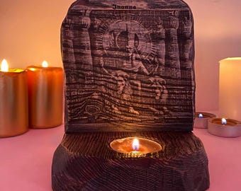 May include: A wooden candle holder with a carved image of a person holding a sword. The holder has a small candle in the centre and the word "Joanna" is written on the top.