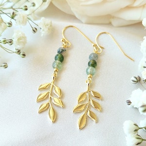 May include: Gold leaf earrings with green agate beads. The earrings are delicate and feminine, perfect for adding a touch of nature to any outfit.