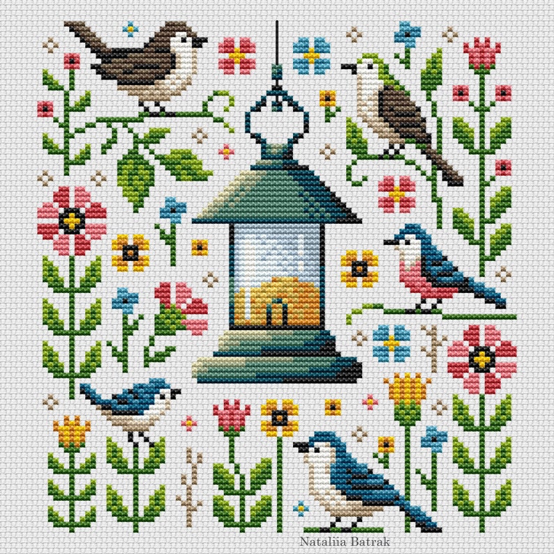 May include: Cross stitch pattern featuring a lantern with a yellow glow, surrounded by colorful flowers and birds. The birds are blue, brown, and pink, and the flowers are pink, yellow, and blue. The pattern is titled "Natalia Batrak".
