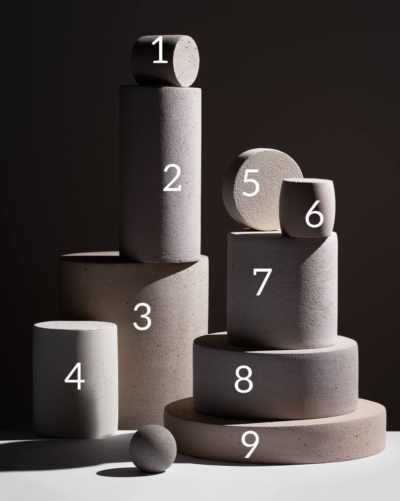 Ten numbered concrete display podiums showing all available sizes from small to large on dark background