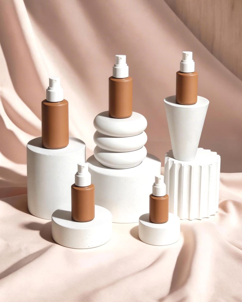 Concrete display riser set for cosmetics, minimal product display stands with skincare bottles, retail merchandising display system for beauty brands