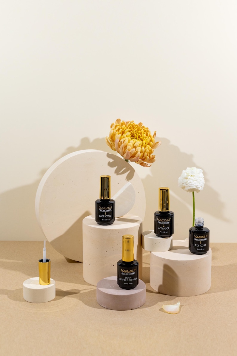 Concrete display risers used as product photography props with nail polish bottles and beauty products on beige background