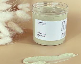 May include: A green tea clay mask in a clear jar with a white label that reads "black honey, clean & natural" and "Green Tea Clay Mask 6oz".