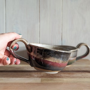 Stoneware soup/latte mug with smokey black glaze and emerald/red glaze layered on the bottom half.