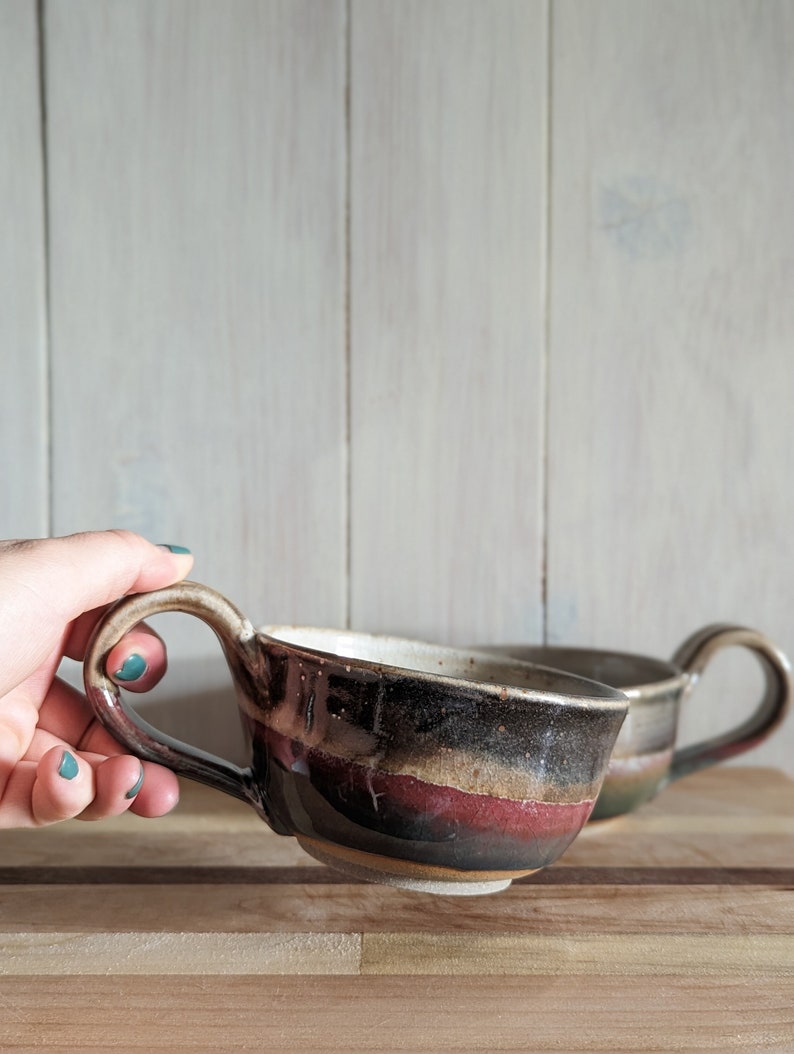 Stoneware soup/latte mug with smokey black glaze and emerald/red glaze layered on the bottom half.