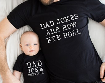 May include: A black t-shirt with the text "Dad Jokes Are How Eye Roll" and a black onesie with the text "Dad Joke Survivor". A man and a baby are wearing the shirts.