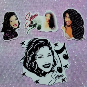 May include: Four Selena Quintanilla-Pérez stickers. One sticker features a black and white illustration of Selena with a music note and stars. Another sticker features a color photo of Selena with a white rose. The third sticker features a color photo of Selena with the text "I'll be dreaming of you" and the fourth sticker features a color photo of Selena with a red rose.