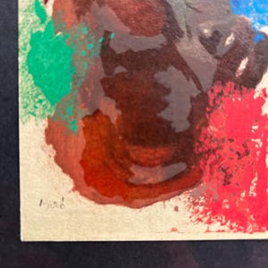 May include: Abstract painting with splashes of red, green, blue, and brown paint. The painting is signed "Miro" in the bottom left corner.