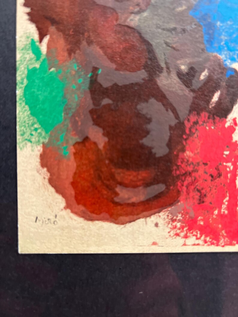 May include: Abstract painting with splashes of red, green, blue, and brown paint. The painting is signed "Miro" in the bottom left corner.