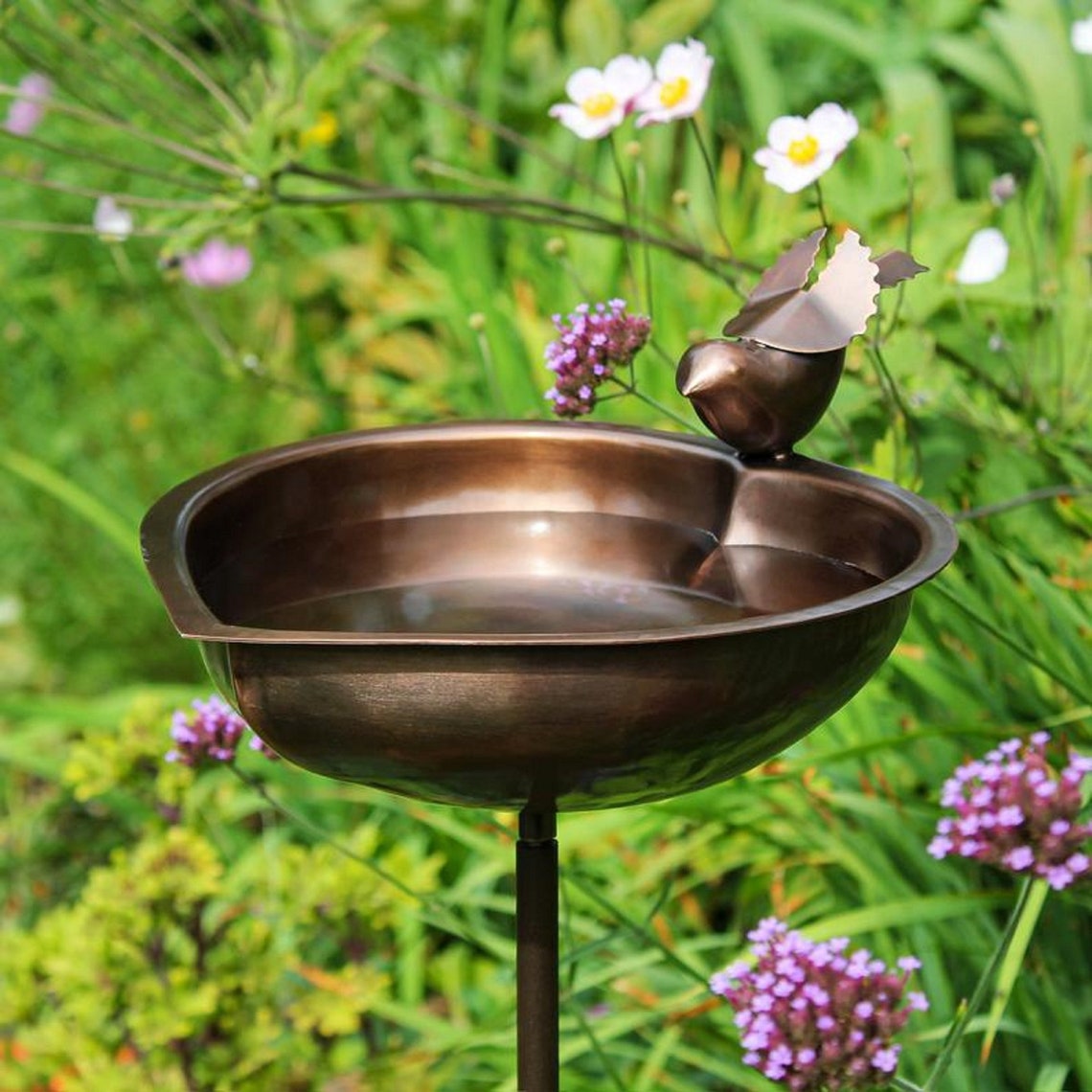 The bird's bath is made of bronze Etsy