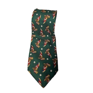 May include: A green necktie with a repeating pattern of cowboy boots in red, white, and gold. The tie has a ribbed texture and small white polka dots scattered throughout the design. A classic accessory for a Western-themed look.