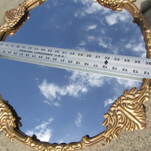 vintage Floral vintage Large Ornate Floral Gothic Victorian Mirror. Gold colored round mid century Wall mirror