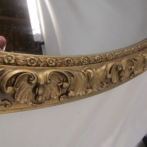 vintage Floral vintage Large Ornate Floral Gothic Victorian Mirror. Gold colored oval mid century Wall mirror