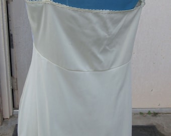 May include: White slip with adjustable straps. The slip has a lace trim at the top and a smooth, silky finish.