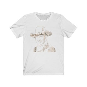 May include: White t-shirt featuring a black and white image of John Wayne's face created from text. The text includes the words "John Wayne" and "Western".