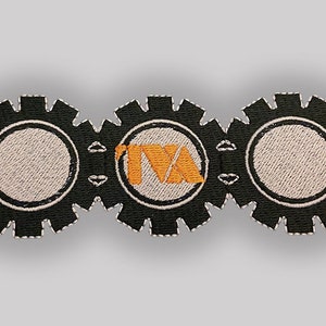 May include: Black and white embroidered patch with three interlocking gears. The center gear has a white circle with the orange text "TNA" inside.