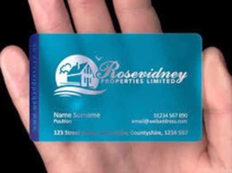 K&ouml;nnte beinhalten: Eine t&uuml;rkisblaue Plastik-Visitenkarte mit einem wei&szlig;en Logo eines Hauses mit einem Vogel und dem Text "Rosevidney Properties Limited". Die Karte enth&auml;lt auch den Namen "Name Surname", eine Position, eine E-Mail-Adresse, eine Telefonnummer und eine Adresse.
