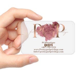May include: A clear plastic business card with a rose gold logo that says "PGP Pretty Gurl Privilege". The card also includes the business name "PGPboutique", social media icons, a phone number, a website address, and an email address.