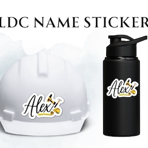 May include: White hard hat with a black and yellow construction themed sticker that says "Alex!" on it. A black water bottle with a similar sticker that says "Alex!" on it.