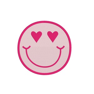 May include: Pink and white smiley face with pink heart eyes. The smiley face is outlined in pink.