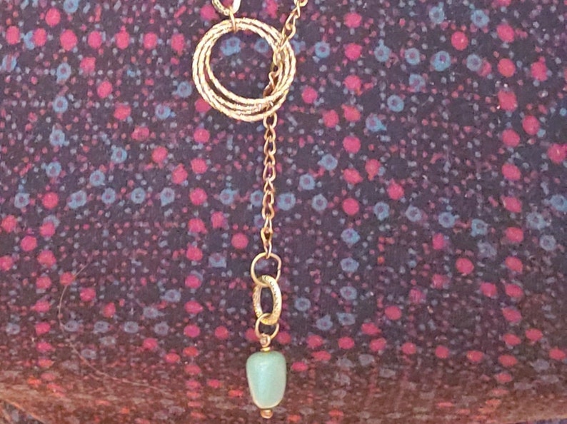 close up picture of the necklace on a model