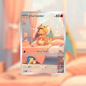 May include: A custom illustrated Charmander Pokémon card. The card features a Charmander wearing a hoodie, sitting on a bed. The card text includes "Heat Tackle" and "HP 60". The card has a silver border and a soft, pastel colour scheme.