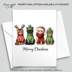 May include: A white greeting card with four cats dressed in holiday attire. The cats wear sweaters, hats, and scarves. The card reads "Meowy Christmas" in cursive. The top of the card reads "PRIORITY MAIL OPTIONS AVAILABLE AT CHECKOUT".