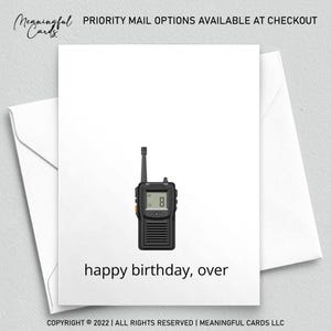 May include: A white greeting card with a black walkie-talkie illustration and the text "happy birthday, over." The card is inside a white envelope. The card has the text "Meaningful Cards" at the top.