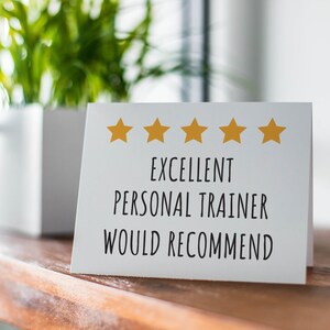 May include: White card with five gold stars and the text "EXCELLENT PERSONAL TRAINER WOULD RECOMMEND".