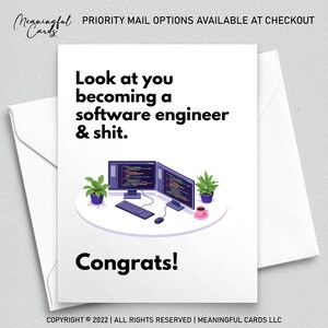 May include: A white greeting card with the text "Look at you becoming a software engineer & shit. Congrats!" The card features an illustration of two computer monitors, a keyboard, a mouse, and a coffee cup. The card is inside a white envelope.