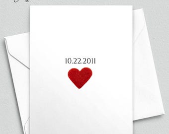 May include: A white card with a red heart and the date 10.22.2011 printed on it. The card has the text "Meaningful Cards" and "PRIORITY MAIL OPTIONS AVAILABLE AT CHECKOUT" printed at the top. The bottom of the card has the text "COPYRIGHT © 2022 | ALL RIGHTS RESERVED | MEANINGFUL CARDS LLC".