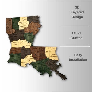 May include: A 3D layered wooden map of Louisiana, featuring various shades of brown, green, and tan. The map is hand-crafted and includes the names of the parishes. Text on the side reads "3D Layered Design", "Hand Crafted", and "Easy Installation".