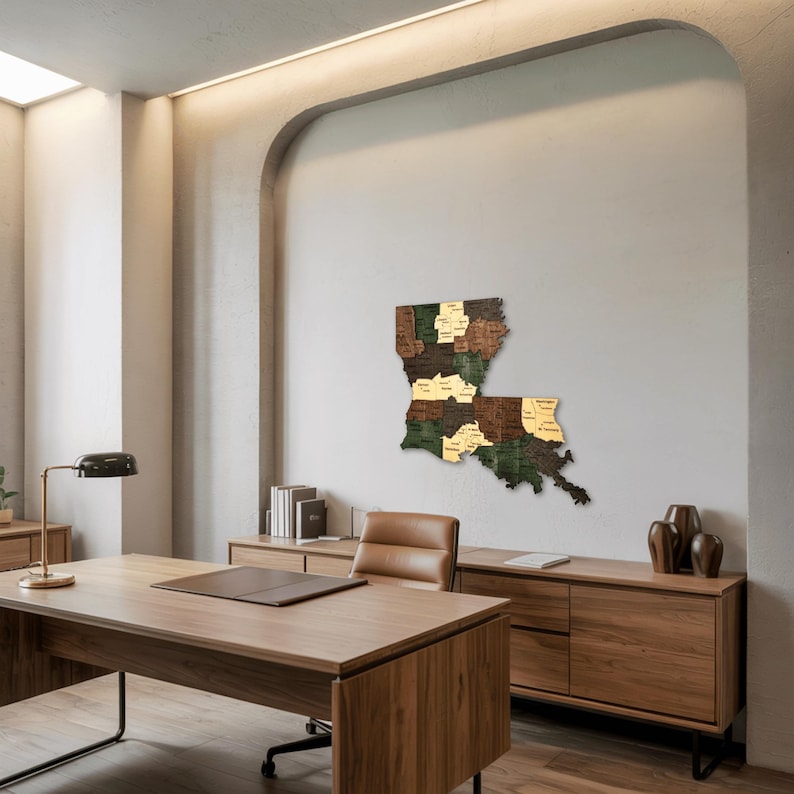May include: A wooden map of Louisiana, mounted on a wall. The map is segmented into parishes, each with a different wood tone, including green, brown, and gold. The map is displayed in a modern office setting.