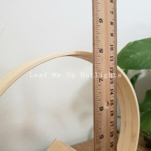 May include: A wooden hoop with a diameter of 15 inches, measured with a ruler. The hoop is made of natural bamboo and is unfinished.