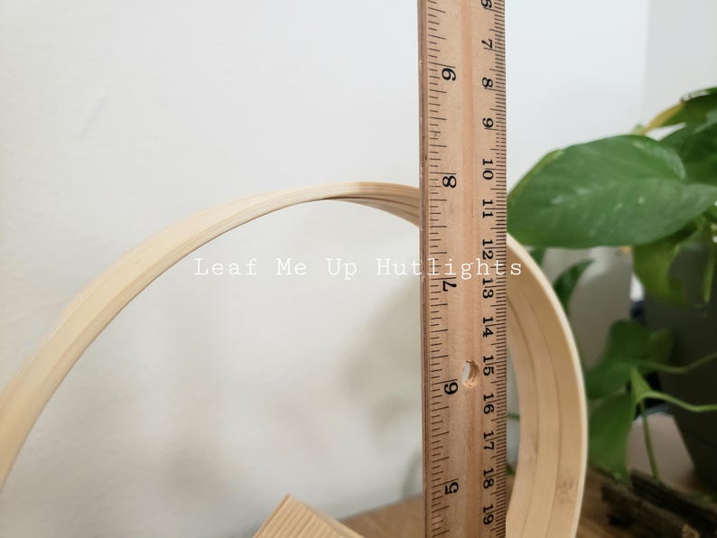 May include: A wooden hoop with a diameter of 15 inches, measured with a ruler. The hoop is made of natural bamboo and is unfinished.