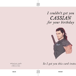 May include: A greeting card with a pink background featuring a cartoon illustration of a man with long dark hair and a sword. The text on the card reads "I couldn't get you CASSIAN for your birthday So I got you this card instead."