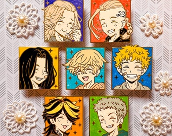 May include: Set of ten enamel pins featuring colorful cartoon characters with different hairstyles and expressions. The pins are gold-toned and have a shiny finish.