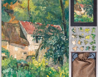 May include: A completed jigsaw puzzle depicting a landscape with a building with a red roof, surrounded by green trees and foliage. A framed version of the image, loose puzzle pieces, and a burlap bag are also visible.