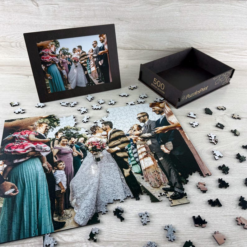 Custom wedding photo puzzle made from a personal picture, wooden jigsaw puzzle with scattered pieces and premium puzzle box.