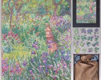 May include: A completed jigsaw puzzle depicting a garden scene with a path, trees, and flowers in shades of green, purple, and red. A framed version of the image, loose puzzle pieces, and a drawstring bag are also present.