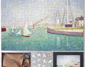 May include: A 1000-piece jigsaw puzzle featuring a pointillist painting of a harbor scene with sailboats and a lighthouse. The puzzle is in a wooden frame and comes with a bag for storage. The image shows a completed version of the puzzle.