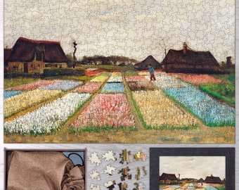 May include: A jigsaw puzzle depicting a field of colorful flowers, likely tulips, with two houses in the background. The puzzle is made of wood and has a light brown finish. The puzzle is in a box with a brown burlap bag and a few puzzle pieces scattered around it.