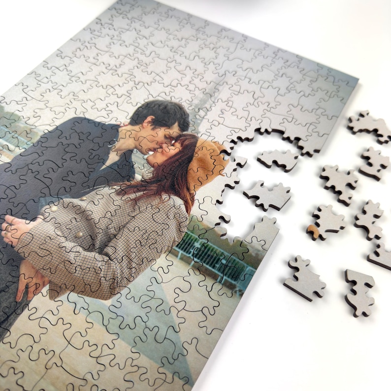 Personalized wooden photo puzzle with loose jigsaw pieces, custom puzzle made from a romantic couple photo.