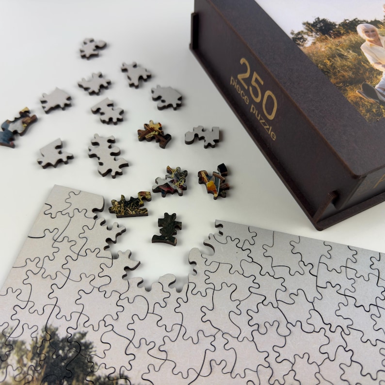 Close-up of personalized wooden puzzle pieces with custom photo puzzle and premium wooden puzzle box.