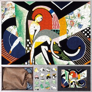 May include: A completed jigsaw puzzle featuring an abstract art design with bold colors and geometric shapes. The puzzle includes a box with a drawstring bag, loose puzzle pieces, and a framed image of the puzzle design.