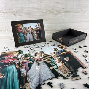 Personalized wooden jigsaw puzzle made from a wedding photo, custom photo puzzle with scattered pieces and premium puzzle box gift.