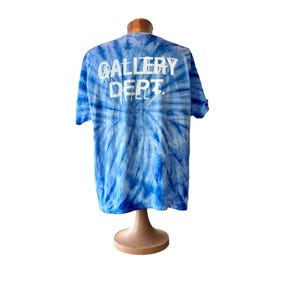 May include: Blue tie-dye t-shirt with white "GALLERY DEPT." text on the back.