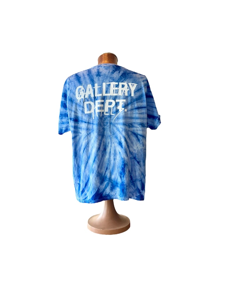 May include: Blue tie-dye t-shirt with white "GALLERY DEPT." text on the back.