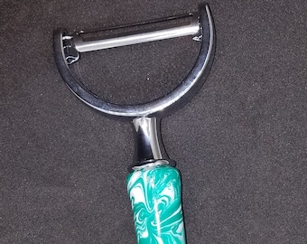 green and white veggie peeler
