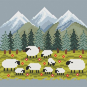 May include: Cross-stitch design featuring a pastoral scene. White sheep with black faces graze in a green meadow dotted with red flowers. Behind them are green pine trees and snow-capped mountains, all against a light blue background.